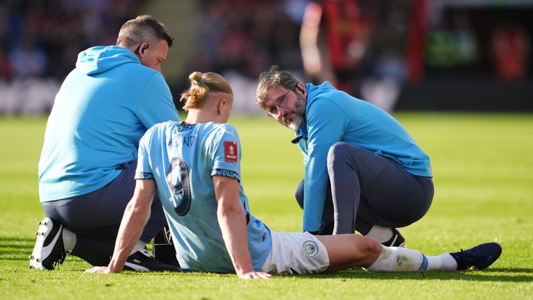 Erling Haaland receives medical treatment after going down with an injury