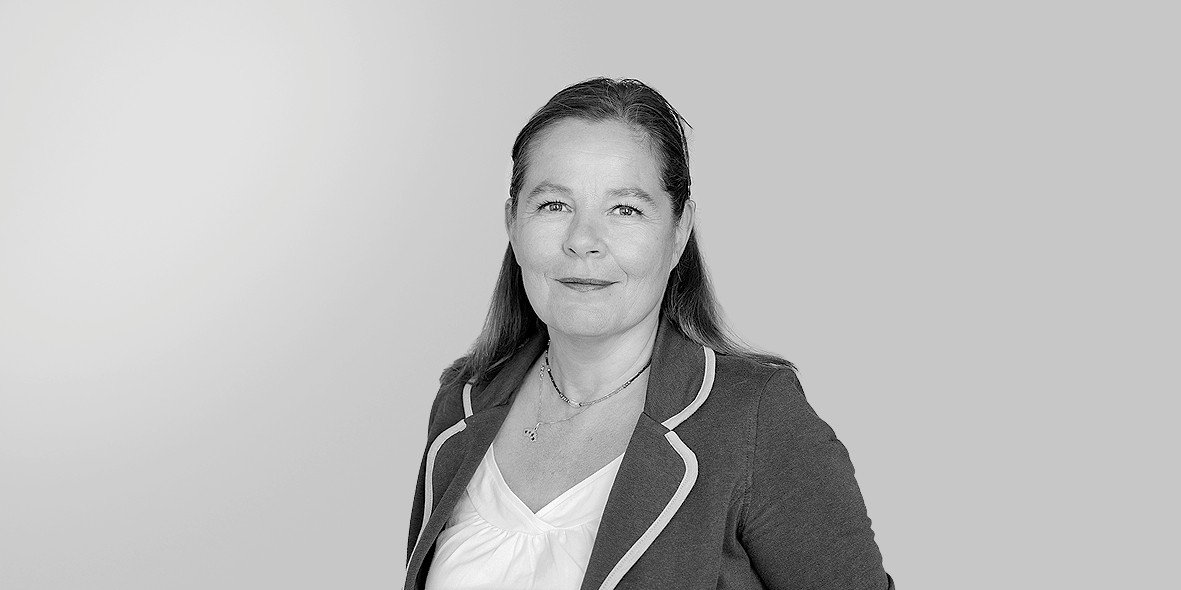 Groupe de jeunes assis dans des gradins de stade, souriant et faisant des signes de paix avec les mains.